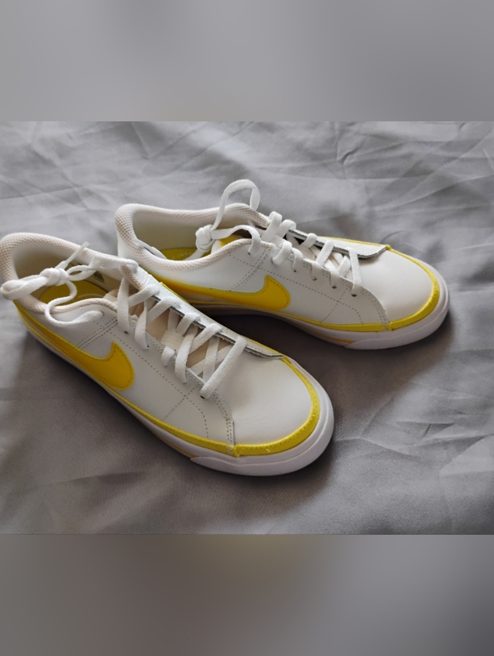 Nike White Low-Top Sneakers with Yellow Swoosh
